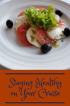 a white plate topped with tomatoes, lettuce and blueberries on top of it