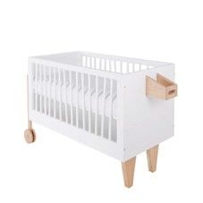 a white crib with wooden legs and drawers on the bottom, in front of a white background