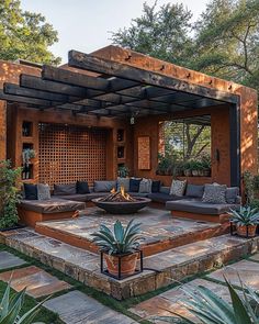 an outdoor living area with couches and potted plants