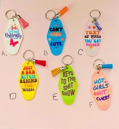 six key chains with different sayings on them