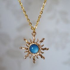 Make a statement with this pretty blue sun drop necklace for women. This cool quirky gold plated and acrylic blue sun necklace is a great way to add a nice touch to your outfit. The charm on this ladies sun necklace measures at 3cm x 2.7cm and is attached to a gold plated chain with lobster clasp. Various lengths of necklace chain are available, please select a length from the drop down menu. Please feel free to get in touch with us at Funky Earrings UK if you have any questions. We also have a wide range of other cute and unusual earrings and necklaces for her in our shop. Cheap Fun Blue Necklaces, Cheap Fun Blue Jewelry, Vintage Necklaces Blue, Cheap Cute Blue Necklaces, Trendy Cheap Blue Necklace, Cheap Trendy Blue Jewelry, Luxury Turquoise Celestial Jewelry, Cheap Hippie Blue Jewelry, Cheap Blue Necklaces