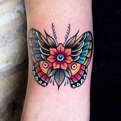 a colorful butterfly tattoo on the arm