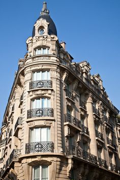 an ornate building with balconies on the top