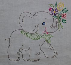 an elephant with flowers on it's back is embroidered onto the side of a white shirt