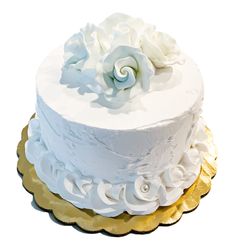 a three layer white cake with flowers on top