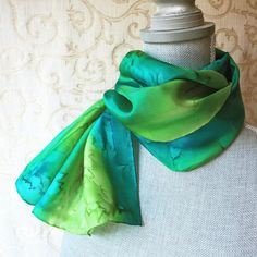 **FREE First Class US mail shipping or upgrade to Priority for only $4 when checking out. (through May 9th).**This silk scarf is hand dyed in tropical shades of peridot and teal greens. Beautiful jewel tones!The silk scarf measures approximately 11” x 60” with hand sewn hems. The French dyes are steam set for permanence and the scarf is hand washable. Each scarf is gift packaged and includes a tying instruction sheet for different ways to wear.  If you are sending as a gift, I can add a matching Green Silk Scarves For Summer, Green Silk Bohemian Scarves, Bohemian Green Silk Scarves, Green Hand Dyed Bohemian Scarf, Handmade Green Bohemian Silk Scarf, Handmade Bohemian Green Silk Scarf, Silk Scarf Painting, Silk Painting, How To Make Notes