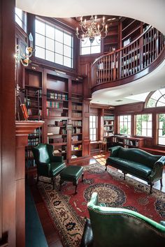 a living room filled with lots of furniture next to a spiral stair case in front of a bookshelf