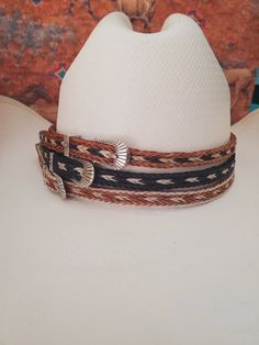 Braided Horse Hair Adjustable Hat Band in Brown/Black/White, Brown/White or Black/White with silver buckle make this hatband a great fit for most hats. This stunning hat band is made from genuine braided horse hair and will compliment your favorite cowboy hat.   - 3 braided strands are sewn together to create this gorgeous hatband. - Hat band measurements: approximately adjusts to 27" around and is 3/8 inch wide - Hat bands are shown on a size 7 hat.  Hats are not included. - See my horse hair KEEPSAKES to have a hat band made from your horse's hair:  https://www.etsy.com/shop/BlueEyesDesignsHB?ref=seller-platform-mcnav§ion_id=43697745 - See my HORSE HAIR hat bands:  https://www.etsy.com/shop/BlueEyesDesignsHB?ref=shop-header-name&listing_id=1296906619&from_page=listing&section_id=50325232 Adjustable Brown Mini Hat For Rodeo, Adjustable Silver Hat Band For Rodeo, Adjustable Wide Brim Silver Mini Hat, Adjustable Silver Mini Hat With Wide Brim, Adjustable White Western Hat Bands, Adjustable White Hat Band For Country Events, Western Adjustable Silver Hat Band, Silver Adjustable Hat For Rodeo, Silver Hat With Adjustable Fit And Short Brim