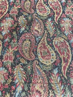 a close up view of a colorful paisley print fabric