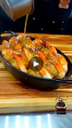 a pan filled with food sitting on top of a wooden cutting board