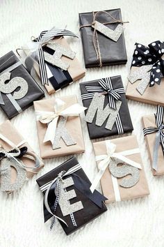 several wrapped presents with bows and letters on them sitting on a white carpeted floor