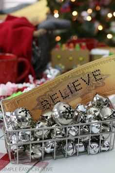 a basket filled with silver bells on top of a table