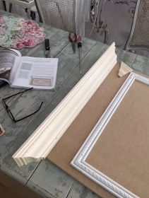 an open book sitting on top of a wooden table next to a pair of glasses