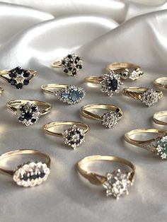 a collection of rings sitting on top of a white cloth