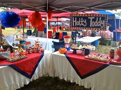 tables with red, white and blue decorations under a tent