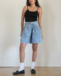 Medium-light wash denim shorts c. late 1980s/early 1990s Liz Claiborne. High-waisted rise with two o-ring belts at center. Zipper fly. Pleated at waistline. Slip pockets at each hip, one pocket at back. Long, relaxed silhouette. Hemline falls lower thigh to knee. composition: 100% cotton label: Liz Wear union-made in USA condition: excellent tag size: 12 modern size estimate: medium - large (please refer to measurements for proper fit) MEASUREMENTS waist - 29" hips - 46" rise - 12" inseam - 9" l Mid-rise Medium Wash Shorts With Belt Loops, Relaxed Fit Denim Knee-length Shorts, Mid-rise Denim Blue Jean Shorts With Belt Loops, High-waisted Denim Blue Shorts With Belt Loops, Vintage Mid-rise Denim Blue Shorts, Long Denim Shorts, Cotton Labels, Union Made, Light Wash Denim