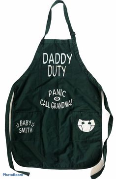 an apron with the words daddy duty on it and two baby's names in white