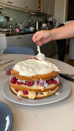 someone is cutting into a cake on a plate