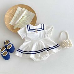 Set sail for cuteness overload with this adorable nautical baby dress! Featuring a classic navy blue sailor collar with white stripes, a darling bow accent, and breathable, lightweight fabric, this dress is perfect for summer adventures and seaside fun. 🌊☀️ Snaps at the back make dressing easy, and the charming nautical style is perfect for any occasion. Order now and let your little one's style set sail! ⛵️✨ Specifications: Gender: Girls Age Range: 6-24 months Pattern Type: Striped Material: C Playful Doll Collar Summer Dress, Playful Summer Dress With Doll Collar, Summer Dress With Striped Collar And Short Sleeves, Spring Sailor-style Short Sleeve Dresses, Blue Sailor Dress With Sailor Collar, Sailor Style Blue Summer Dresses, Blue Sailor Summer Dresses, Blue Sailor Style Summer Dresses, White Summer Dress For School