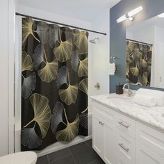 a bathroom with a shower curtain, sink and toilet