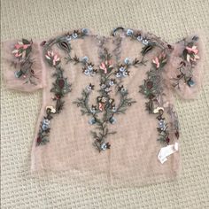 Never Been Worn Zara Sheer Shirt With Embroidery. Love The Shirt But Never Had A Chance To Wear It. The Embroidery Details Are Gorgeous. Material Is 100% Viscose. Has A Button In The Back (Comes With Back Up Button). Size Small. Feminine Embroidered V-neck Blouse, Spring Crew Neck Blouse With Floral Embroidery, Spring Floral Embroidery Crew Neck Blouse, Spring Floral Embroidery Blouse With Crew Neck, Spring Embellished Short Sleeve Tops, Spring Blouse With Floral Embroidery And Crew Neck, Embellished Short Sleeve Tops For Spring, Spring Embroidered Crew Neck Blouse, Elegant Summer Top With Tonal Embroidery