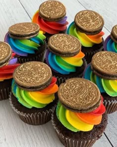 chocolate cupcakes decorated with rainbow and gold oreo cookies