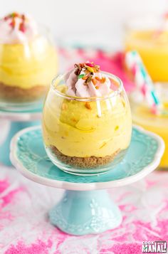 two desserts are sitting on top of each other in glass dishes with sprinkles