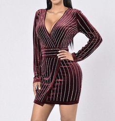 You'll be dazzling all night in this hot little number which features a deep plunging v neck, long sleeve, figure flattering dripping in rhinestone diamonds with back zip closure! Velvet DressDiamond Style GrommetsLow Surplice V NecklineLong SleeveLinedZipper Back100% Polyester V-neck Mini Dress With Rhinestones For Night Out, Embellished V-neck Bodycon Dress For Night Out, Embellished V-neck Mini Dress For Date Night, Embellished V-neck Bodycon Dress, Fall Embellished V-neck Mini Dress, V-neck Embellished Mini Dress For Club, Embellished V-neck Mini Dress For Club, V-neck Rhinestone Mini Dress For Night Out, V Neck Velvet Dress