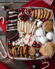 a box filled with cookies and candy canes on top of a red table cloth