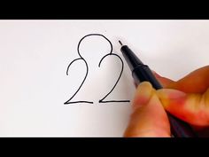 someone is drawing the number two on a piece of paper with a marker and pen