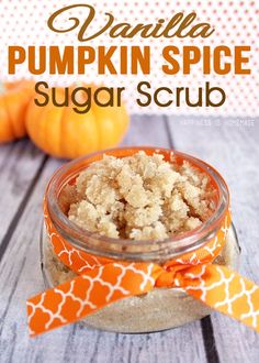 pumpkin spice sugar scrub in a glass jar with an orange and white bow on it