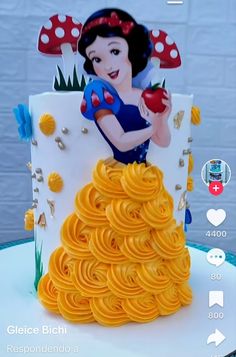 the cake is made to look like snow white and has yellow spirals on it