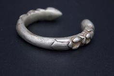 Single medium size solid Silver alloy bracelet. These are also called Bunge Bala. It has a thorn-like carving at each end and round polished finials. These are worn by women of various tribal groups for centuries. wt: 106g diameter: 5.5cm circumference: 14.5cm origin: Nepal Medieval Engraved Jewelry For Ceremonial Occasions, Metal Bracelets With Antique Finish For Ceremonial Occasions, Antique Silver Hand Cast Bracelets, Ceremonial Oxidized Finish Bracelets For Festivals, Antique Hand Cast Bangle Bracelet, Ceremonial Metal Bracelets With Antique Finish, Medieval Engraved Bracelet Jewelry, Antique Bracelets For Ceremonial Festivals, Vintage Antique Silver Bracelets For Festival