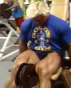 an old man sitting on top of a bench with his legs crossed and feet bent