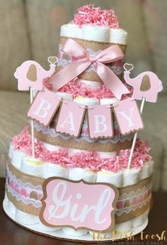 a baby girl diaper cake with pink and brown decorations