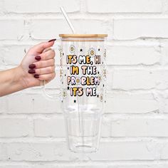 a person holding up a tumbler cup with the words time in the future it's me on it