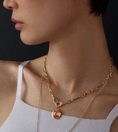 Description Handcrafted in 18-karat Yellow Gold and red ceramic, this Strength Small Mixed Clip Chain Necklace is a reminder that Strength is within. We all have it, but sometimes it wanes, and we need to call on it. The lion symbolizes strength, dignity, passion, self-confidence, and solar energy. The tiger represents a quieter, steely strength. We all have both solar and lunar energies inside of us. Sometimes it takes greater strength to pull back and then to push forward. It is time to harnes Luxury Red Enamel Necklaces, Red Gold Chain Necklace For Gifting, Gift Red Gold Chain Necklace, Red Clavicle Chain Pendant Necklace, Red Pendant Chain Necklace With Clavicle Chain, Gift Red Chain Necklace With Gold Chain, Solar Lunar, Red Ceramic, The Tiger