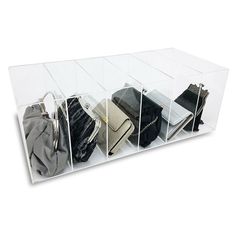 a clear acrylic display case holds purses and handbags