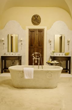 a bath tub sitting in the middle of a bathroom