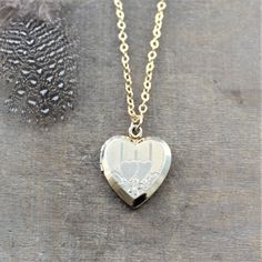 "This vintage locket is engraved with a double heart design on the front; the reverse is plain. The 12k gold filled heart opens revealing two frames in which to place your favorite photos. The locket hangs from a new 14k gold filled cable chain finished tiny gold balls at the lobster clasp closure. Locket 24x20mm Necklace length 18\" (45cm) ✦All of our vintage lockets ship with complimentary insurance✦ ✤Our entire selection of lockets can be found here✤ http://www.etsy.com/shop/LexiandGem?sectio Brass Heart Charm Necklace For Wedding, Brass Heart Pendant Jewelry For Wedding, Brass Heart Pendant Wedding Jewelry, Double Heart Charm Locket Necklace For Wedding, Double Heart Locket Necklace With Heart Charm For Wedding, Victorian Jewelry With Heart Charm For Anniversary, Double Heart Locket Necklace For Wedding, Personalized Heart Pendant Locket Necklace For Wedding, Heart-shaped Brass Jewelry For Wedding