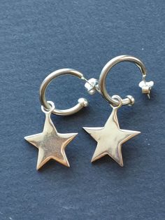 "Pierced Sterling silver 3/4\" star earrings.   Star dangles from hoop." Silver Star-shaped Sterling Silver Hoop Earrings, Small Hoop Sterling Silver Earrings With Star Charm, Silver Star-shaped Jewelry With Dangling Charms, Silver Dangle Hoop Earrings With Star Charm, Star-shaped Hoop Earrings With Dangling Charms, Star-shaped Hoop Earrings With Dangling Charms For Gift, Silver Star-shaped Earrings, Star Shaped Hoop Earrings With Dangling Charms For Gift, Silver Small Hoop Jewelry With Star Charm