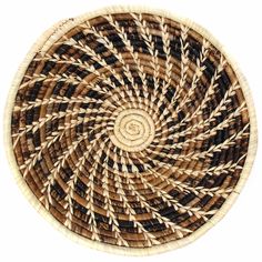 a brown and black woven basket on a white background with the center circle made out of strips of yarn