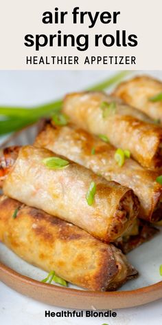 an image of spring rolls on a plate with text overlay that reads air fryer spring rolls healthier appetizer