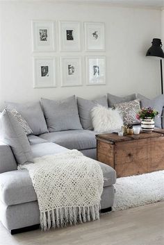 a living room filled with lots of furniture and pictures on the wall above it's coffee table