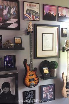 a wall with guitars and pictures on it