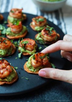 shrimp and guacamole appetizers on crackers are ready to be eaten