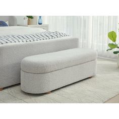 a white couch and ottoman in a room