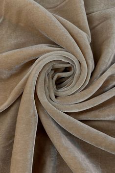 a close up shot of the fabric on a plain tan colored cloth with very thin folds