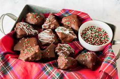 chocolate covered candies with sprinkles on a red and green plaid cloth