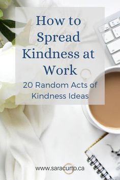 a cup of coffee sitting on top of a desk next to a keyboard and flowers